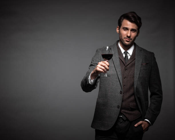 istock Handsome young man with a glass of wine 942611050