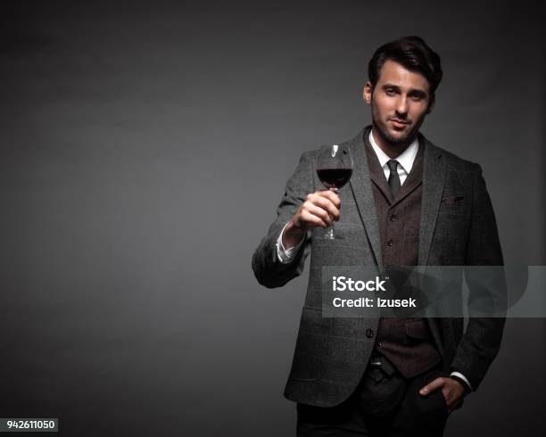 Handsome Young Man With A Glass Of Wine Stock Photo - Download Image Now - Men, Wine, Fashion Model