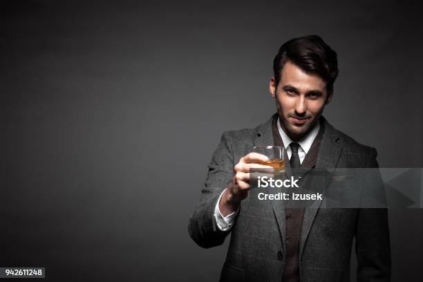 Portrait Of Handsome Man Drinking Whiskey Stock Photo - Download Image Now - Whiskey, Men, Drinking