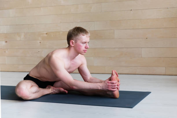 istock Sporty man practicing yoga 942611378