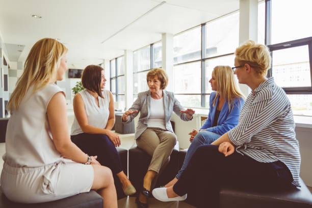 Women at the training, sitting in circle and talking.