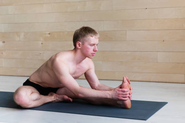 istock Sporty man practicing yoga 942611760