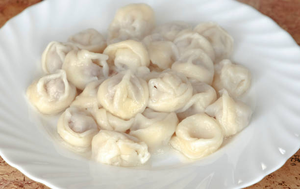 istock Dumplings on a plate on wooden table. 942611788