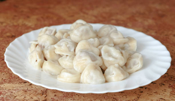 istock Dumplings on a plate on wooden table. 942611832