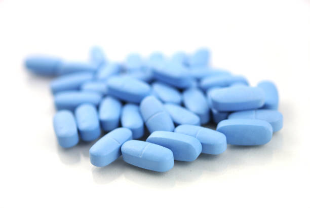 istock Blue oval tablets close-up on white background 942611838