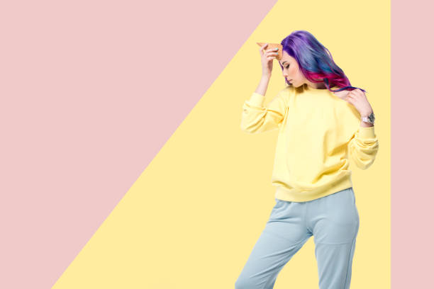 istock attractive young woman pretending unicorn with waffle cone on forehead on creative background 942612606