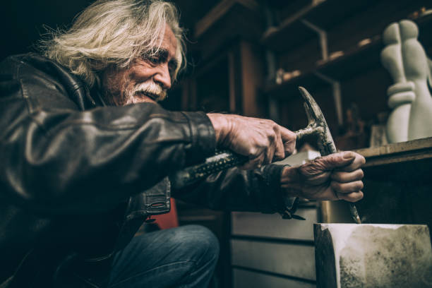 istock Happy senior artist making artwork 942612788