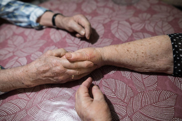 istock Sixty years together.The old couple is holding hands on table 942615742