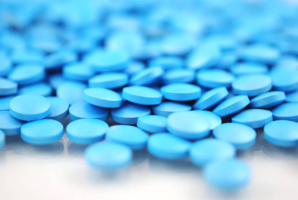 Blue round tablets close-up on white background