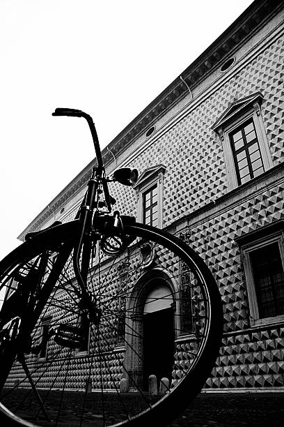 Photo of a young African - American man, using his cargo bicycle to run the errands around the city