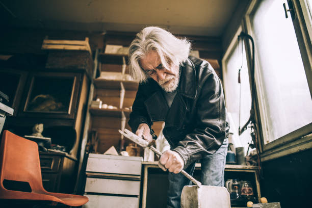 istock Senior Stonecutter working indoors 942616130