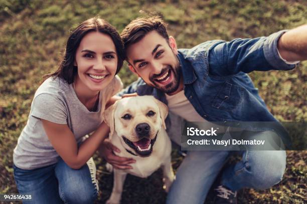 Couple With Dog Stock Photo - Download Image Now - Dog, Couple - Relationship, Pets