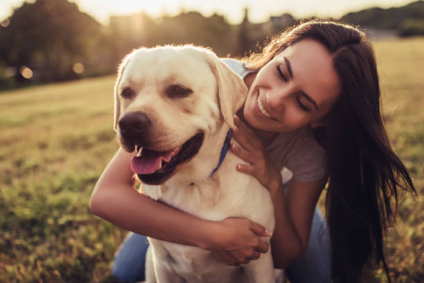 istock Young woman with dog 942616498