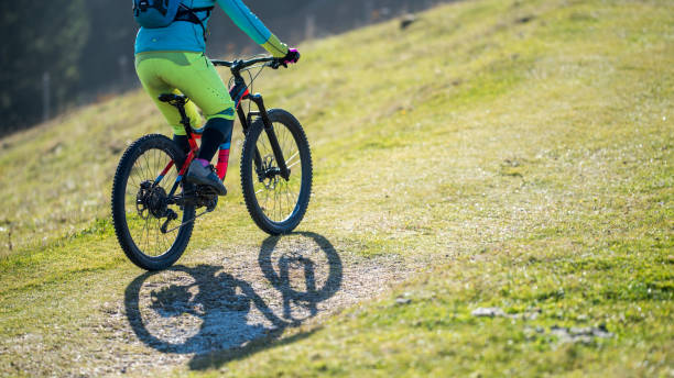 istock Woman riding mountain bike 942619718