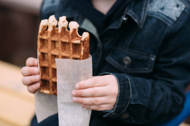 istock Cute girl eating waffle in the yard 942620098