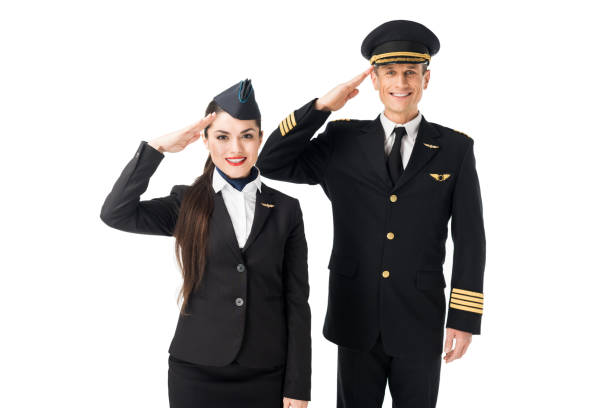 istock Young stewardess and pilot saluting isolated on white 942622674