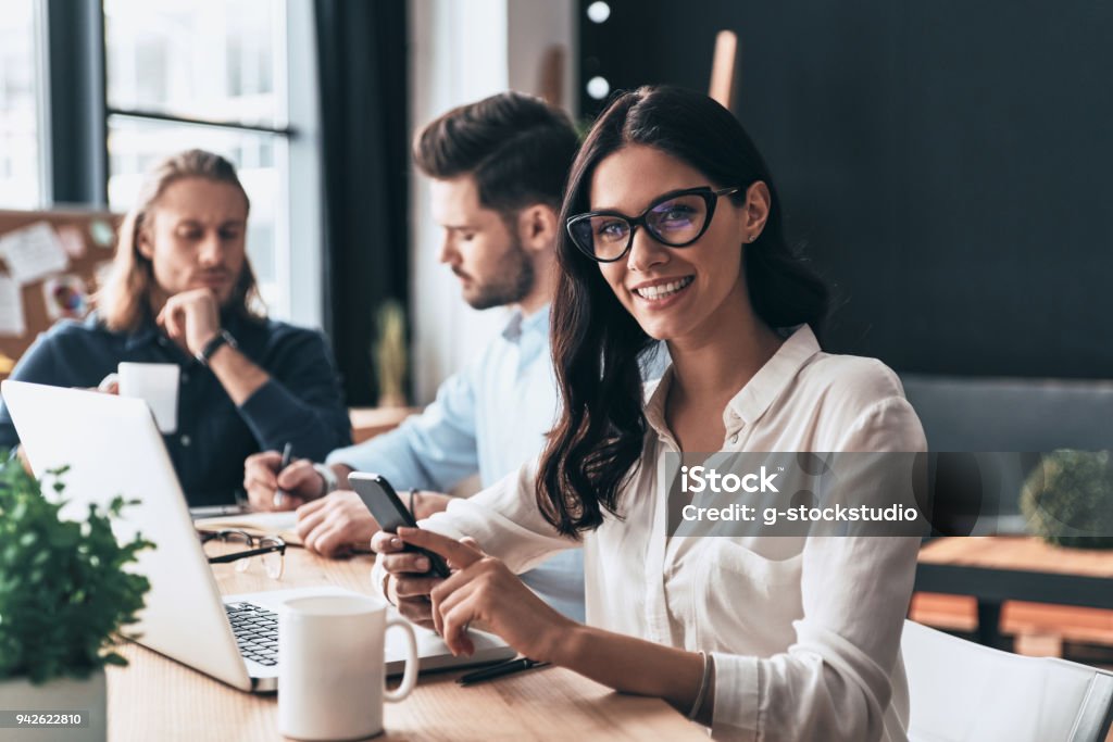 Confident and successful. Young modern colleagues in smart casual wear working while spending time in the office Office Stock Photo