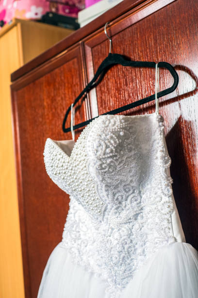 istock Wedding dress hanging 942626594