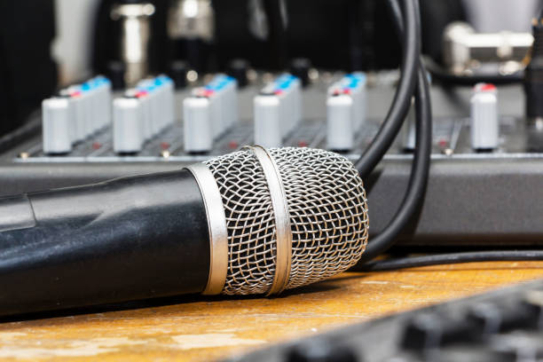 istock Professional condenser studio microphone over the musician blurred background and audio mixer, Musical instrument Concept. 942626864