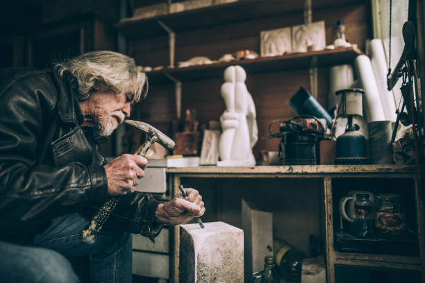 istock Senior Stone cutter artist 942626904