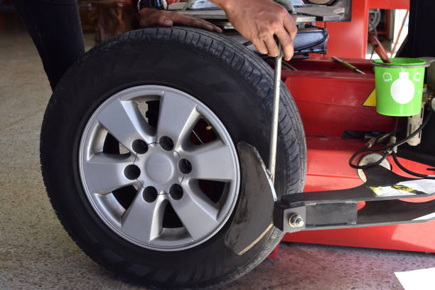 istock Worker use tire changer machine to take out tire from alloy wheel. 942627410