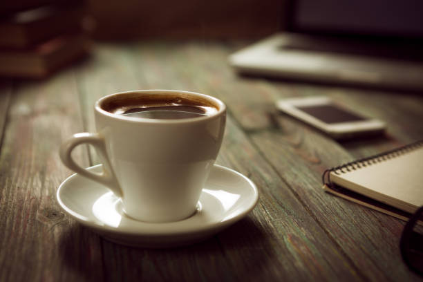 istock A cup of coffee in the workplace on a wooden table. 942628640