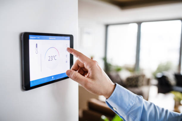 istock A man pointing to a tablet with smart home screen. 942631070