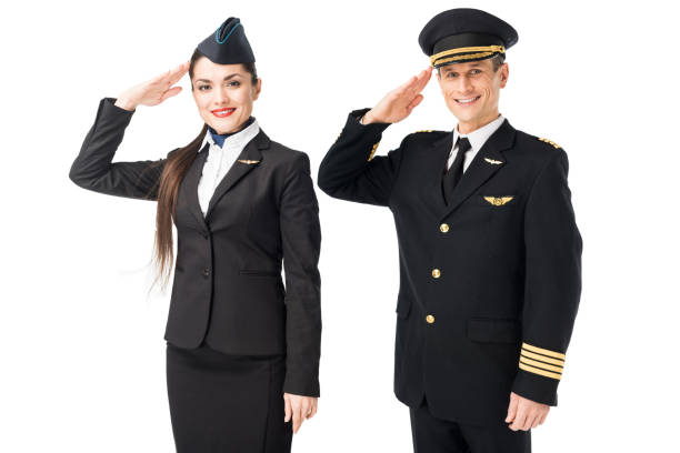 istock Airline captain and stewardess saluting isolated on white 942631094