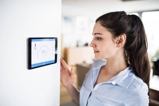 istock A woman looking at tablet with smart home screen. 942631154