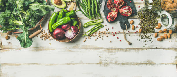 istock Winter vegetarian food cooking ingredients over white background, vertical composition 942631370