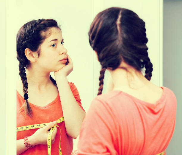 istock Girl sad measuring breast 942631812