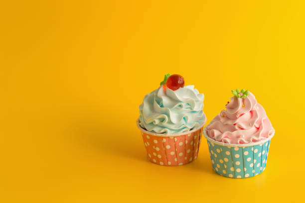 istock Tasty Birthday cupcake on yellow color background 942632344