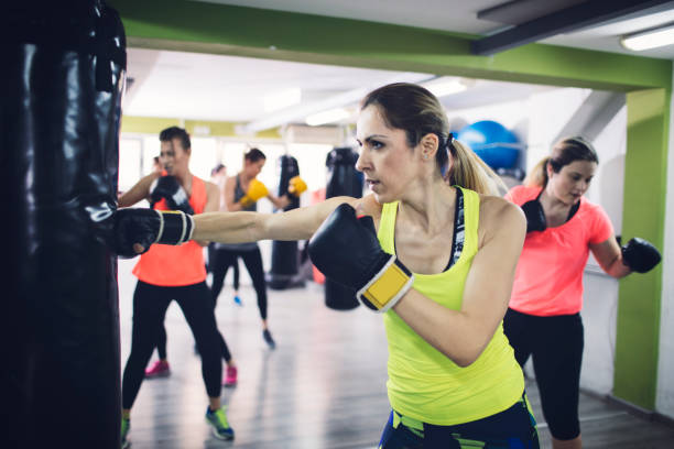istock Women Practicing Boxing In The Gym 942634956