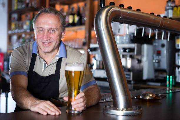 istock Barman is standing with golden beer 942635096