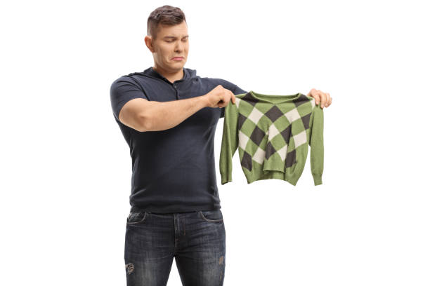 Upset Young Man With A Shrunken Blouse Stock Photo - Download