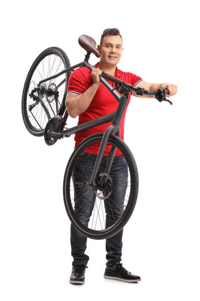 istock Young man holding a bicycle on his shoulder 942635682