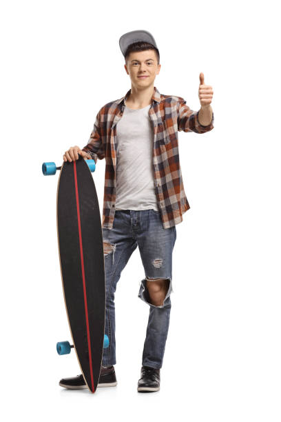 istock Teenage hipster with a longboard making a thumb up sign 942635740