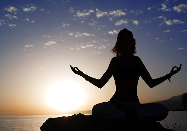 istock young women in lotus pose 94263631