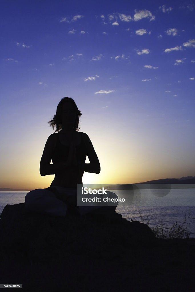 young women in lotus pose  Adult Stock Photo