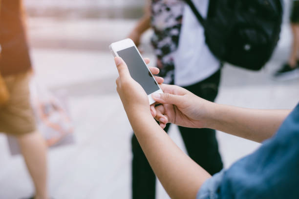 istock Woman use mobile phone in the city 942642086