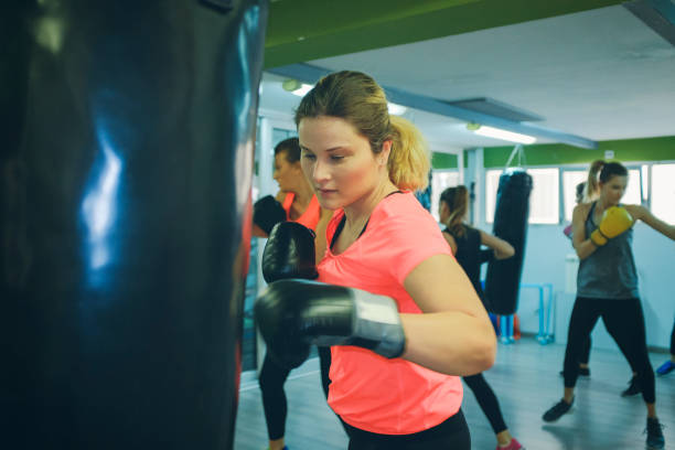 istock Women Practicing Boxing In The Gym 942642136