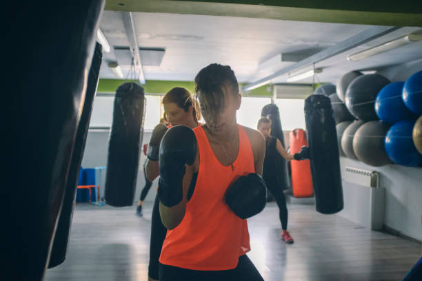 istock Women Practicing Boxing In The Gym 942643260