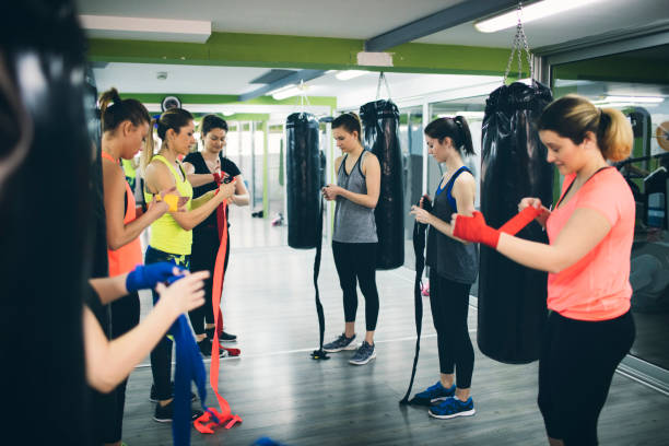 istock Women Practicing Boxing In The Gym 942643380