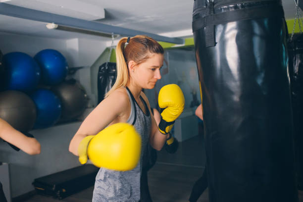 istock Women Practicing Boxing In The Gym 942643438