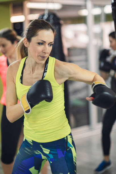 istock Women Practicing Boxing In The Gym 942646564