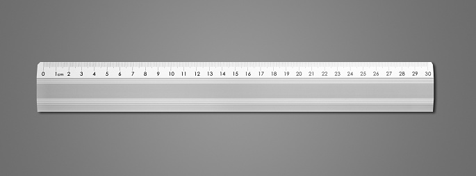 Steel metallic ruler isolated on dark grey background