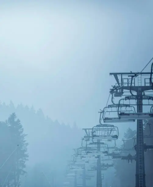Ski chairlift in mist. Winterberg, Germany.