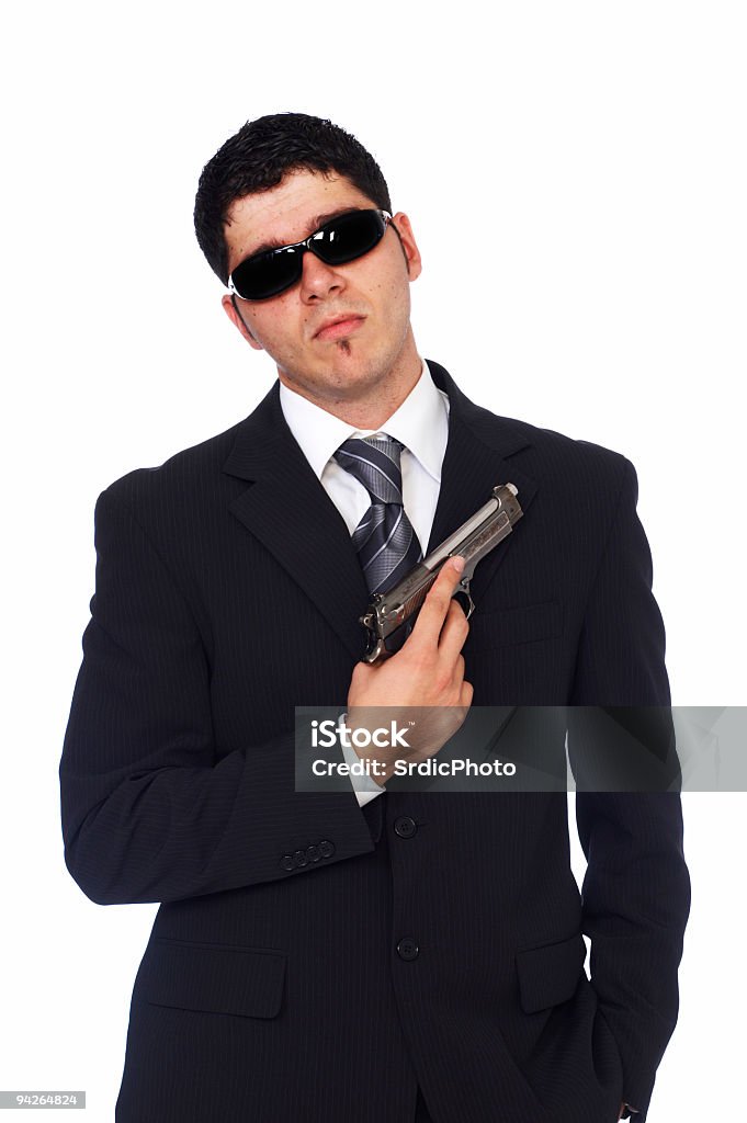 Retrato de homem segurando arma vestindo preto terno e óculos de sol - Foto de stock de Adulto royalty-free