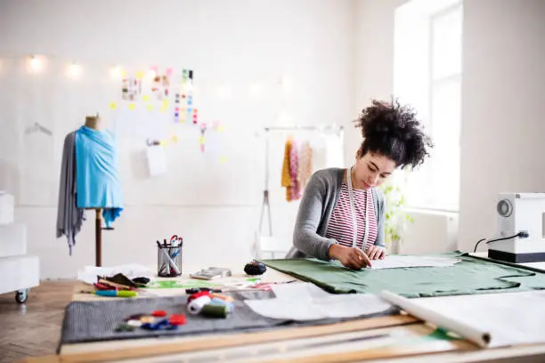 Young creative woman working in a studio, startup business.