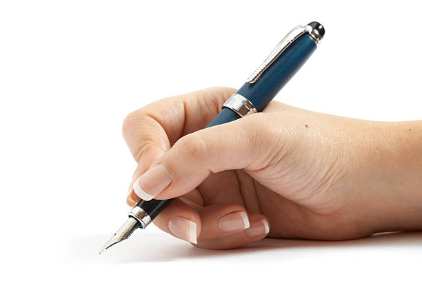 Pen in the beautiful right woman's hand stock photo